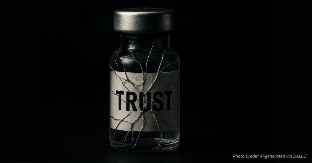 Cracked vaccine vial labeled ‘Trust’ representing fragile faith in science