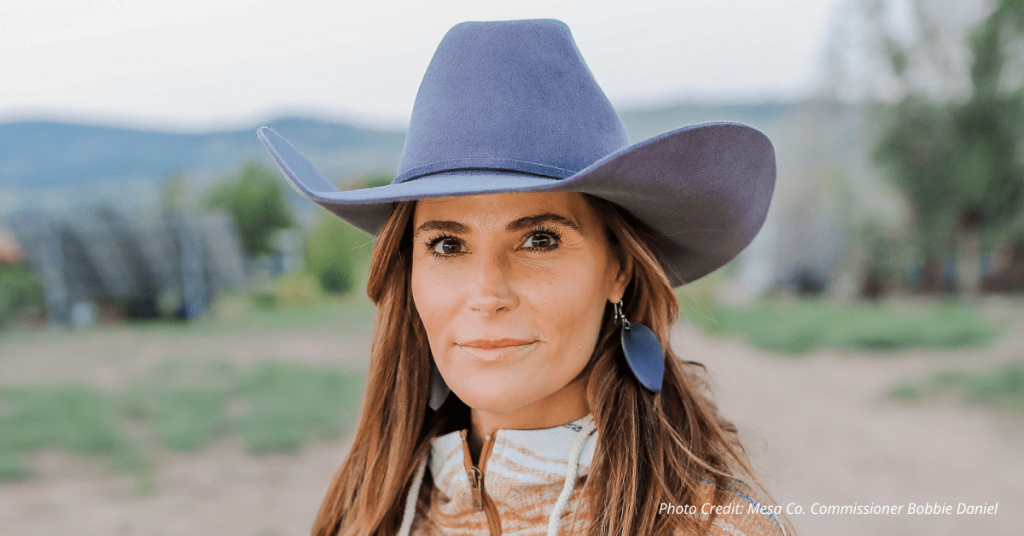 Mesa County Commissioner Bobbie Daniel wearing a cowboy hat, standing outdoors