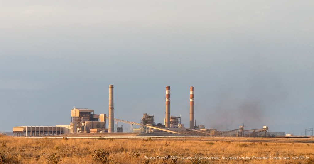 Coal smoke rises from Comanche Power Station in Pueblo, Colorado under a hazy sky