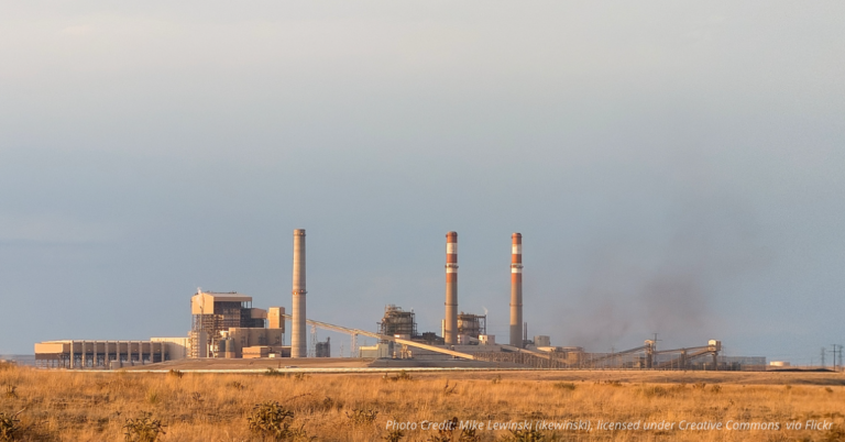 Coal smoke rises from Comanche Power Station in Pueblo, Colorado under a hazy sky