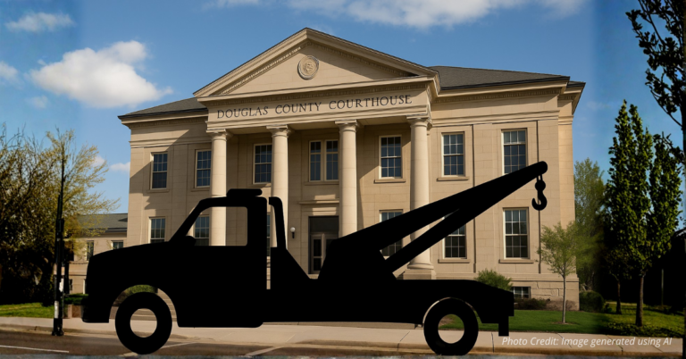 Courthouse with tow truck silhouette symbolizing Colorado justice