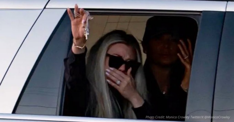 Erika Kirk holds up cross from car window in emotional tribute