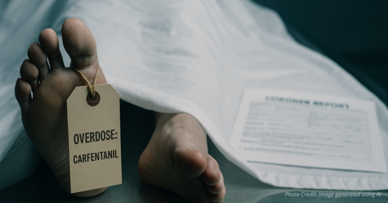 Body on morgue table with toe tag labeled ‘Carfentanil overdose’ symbolizes rising death toll