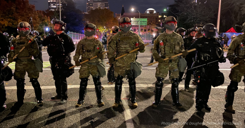 National Guard and federal officers stand in formation in Portland following court ruling
