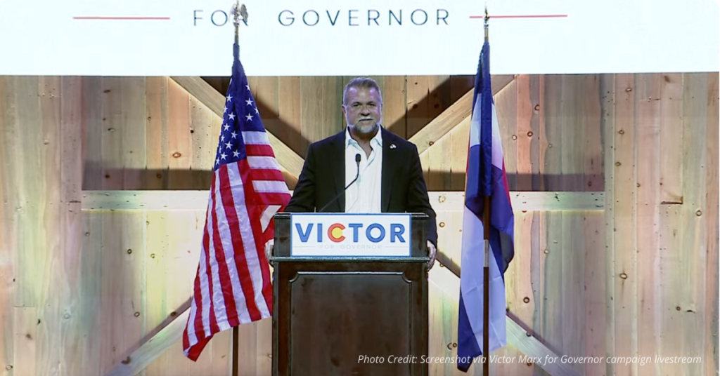 Victor Marx at podium flanked by American and Colorado flags