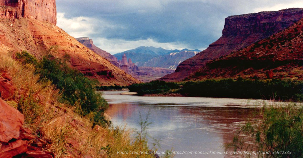 Colorado River winding through Canyon Mountains in the background.