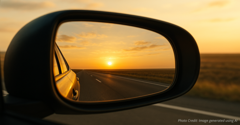 Sunrise reflected in car mirror symbolizing perspective and peace