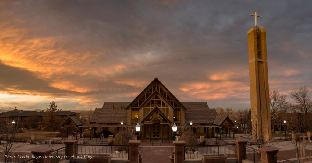 Regis University chapel and bell tower at sunset with dramatic clouds