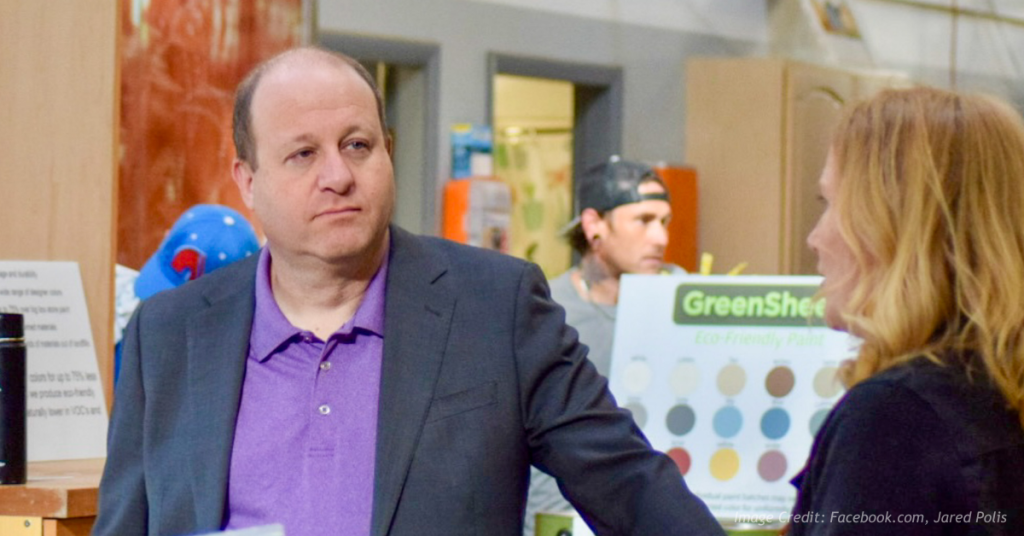 Judge blocks Jared Polis's request to throw out lawsuit.