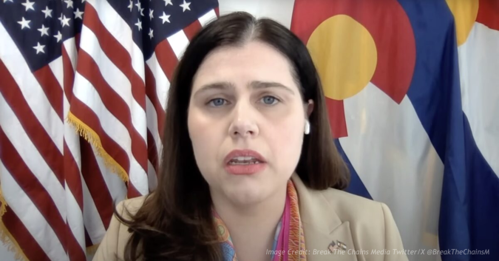 Jena Griswold speaks in front of U.S. and Colorado flags amid dispute over DOJ request for unredacted voter data