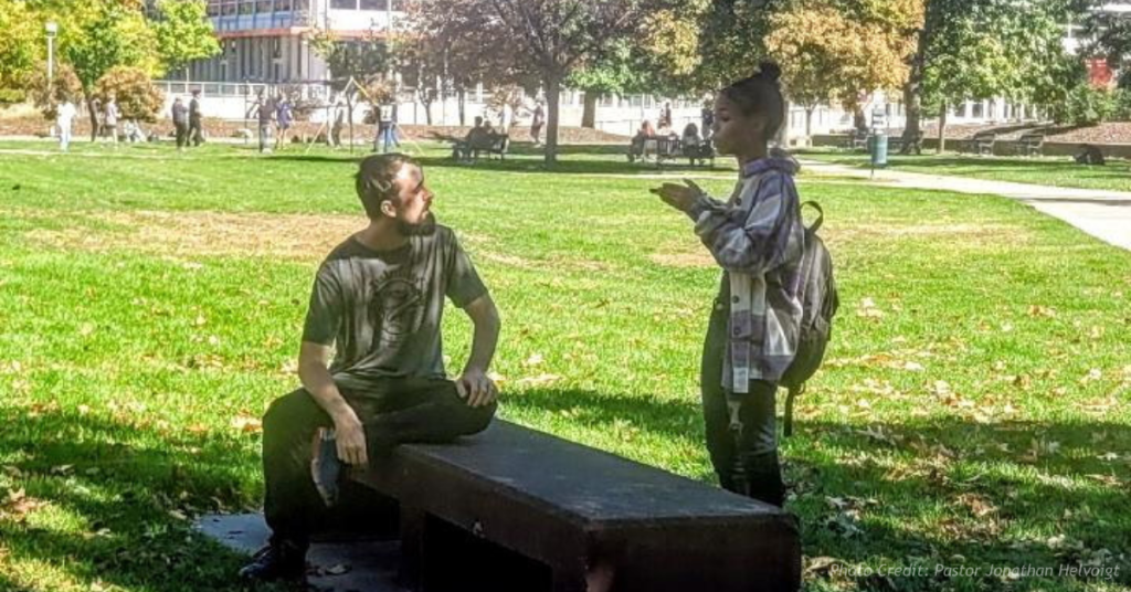 John Scarboro speaks with a student during an evangelism outing at MSU Denver
