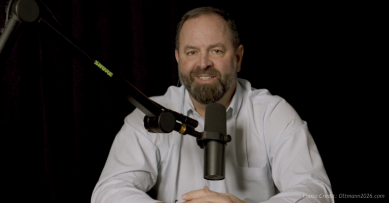 Joe Oltmann speaks into a microphone during a studio recording for his 2026 gubernatorial campaign