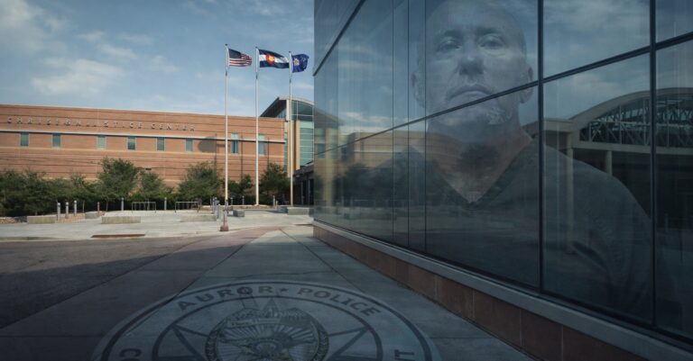 Christensen Justice Center in Colorado with reflection of retired Aurora sergeant facing criminal charges