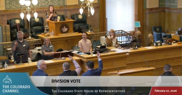 Members of the Colorado House stand during a division vote on HB 26-1144 in the House chamber.