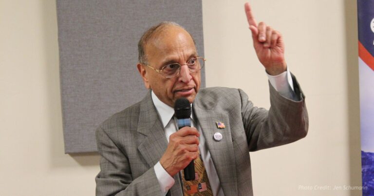 Dr. Janak Joshi speaks at Republican candidate forum in Durango, gesturing while holding microphone