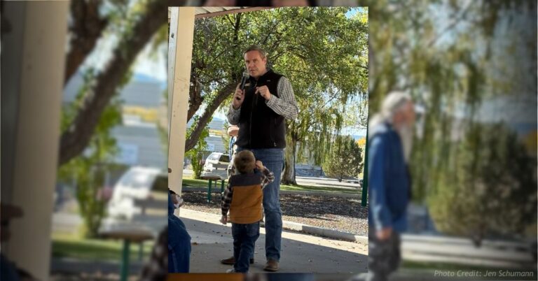 Rep. Jeff Hurd speaks at a 2024 campaign event in Nucla, with his son standing in front of him.