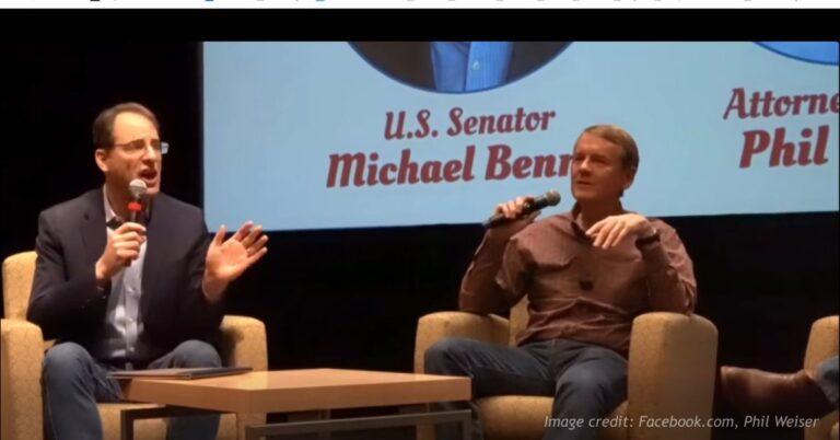 Michael Bennett and Phil Weiser on stage debating.