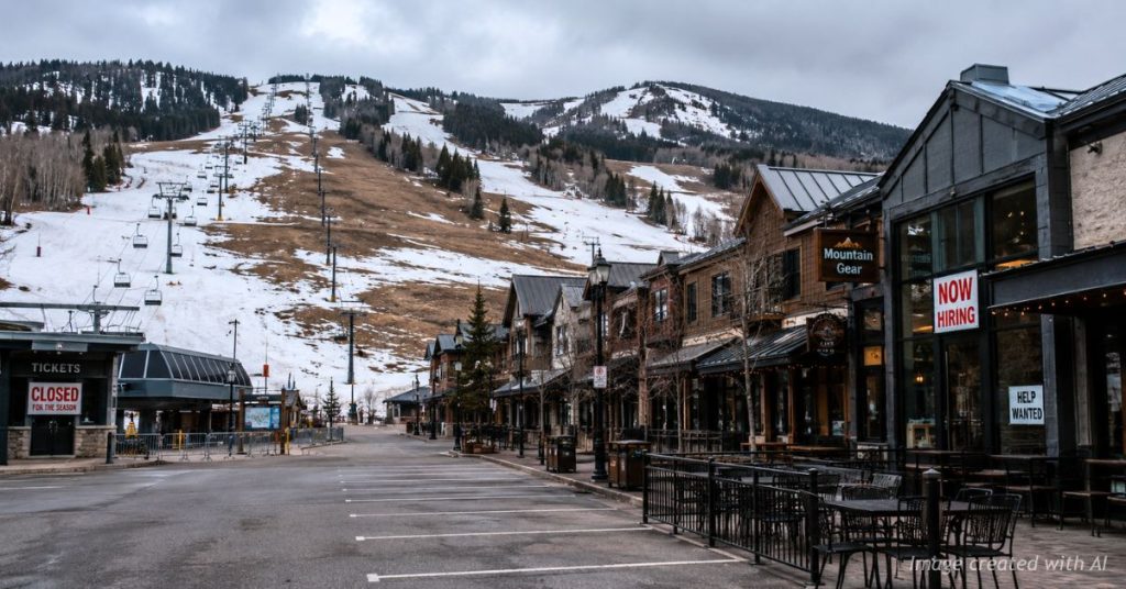 EmSparse snow and quiet businesses in a Colorado ski town during a dry winter.pty ski town with snowless slopes.