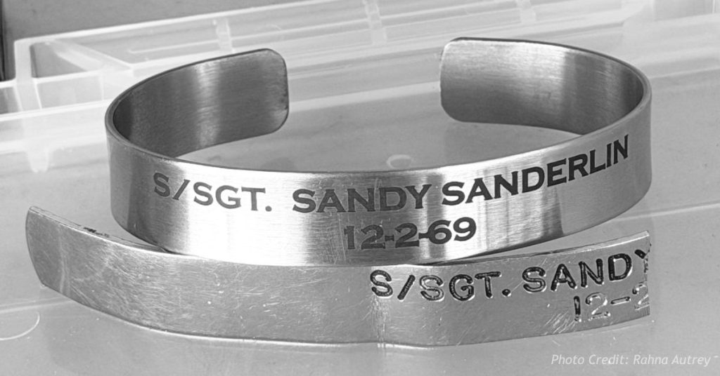 Original and replica POW bracelets engraved with Staff Sgt. Sandy Sanderlin's name and Dec. 2, 1969 loss date.