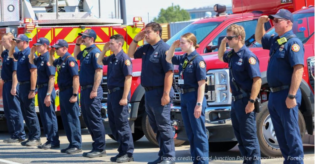 Firefighters salute in honor of fallen wildfire pilot Nicholas Dale during a tribute in Colorado.