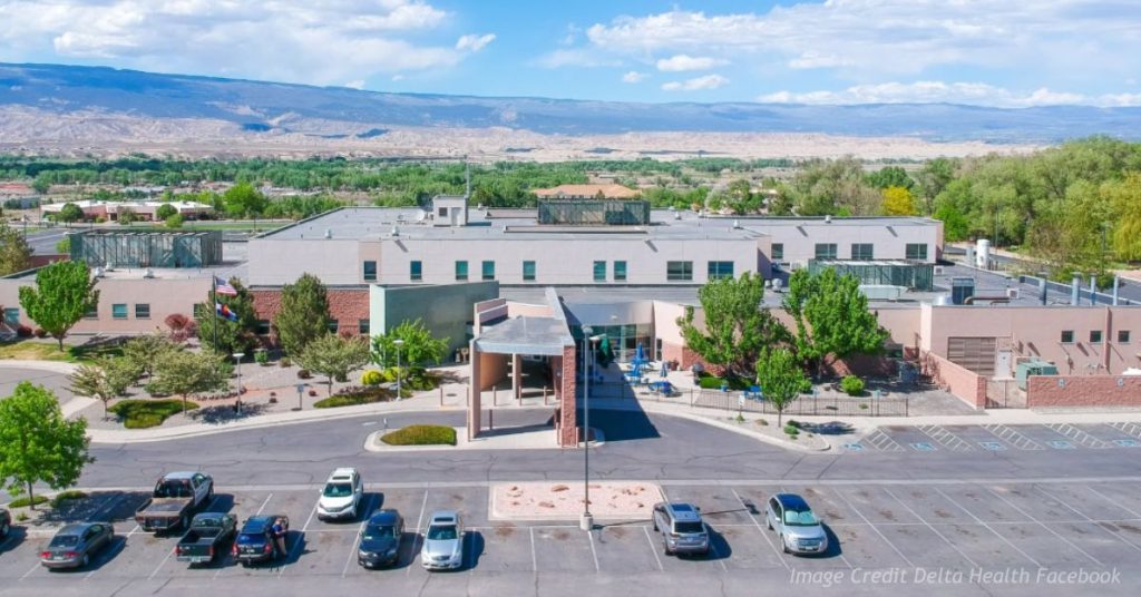 Aerial view of Delta Health Hospital in Delta, Colorado, with mountains and the Western Slope landscape in the background.