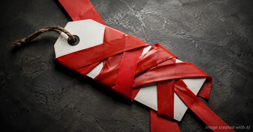 Price tag wrapped in red tape representing regulation and rising consumer costs.