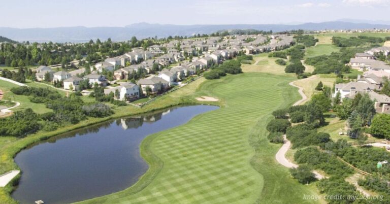 Aerial view of The Ridge at Castle Pines with homes, golf course and Colorado foothills.
