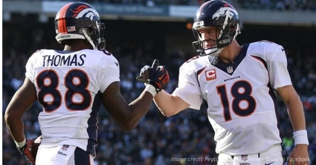 Peyton Manning and Demaryius Thomas greet each other on the field while playing for the Denver Broncos.