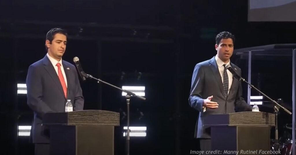 Gabe Evans and Manny Rutinel stand at debate podiums during Colorado's 8th Congressional District race in Berthoud.