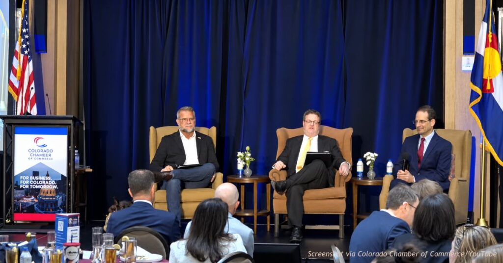 Victor Marx and Phil Weiser take questions from moderator Ed Sealover at the Colorado Chamber of Commerce forum in Denver